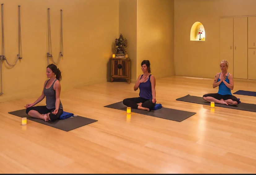 students practicing breath and gentle yoga in studio